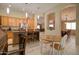 Bright kitchen features a central island with bar stools and a view into the adjacent dining area at 14298 W Amelia Ave, Goodyear, AZ 85395
