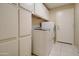 Laundry room boasts ample cabinet space and modern appliances, combining utility with convenient design at 14298 W Amelia Ave, Goodyear, AZ 85395