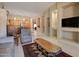 Open-concept living area with a kitchen view, comfortable seating, and lots of natural light at 14298 W Amelia Ave, Goodyear, AZ 85395