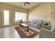 Bright living room with a comfortable sofa, a large window, and a neutral color palette at 14298 W Amelia Ave, Goodyear, AZ 85395