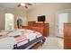 Spacious bedroom featuring a bathroom doorway and a coordinating dresser at 14298 W Amelia Ave, Goodyear, AZ 85395