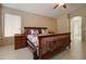 Brightly lit bedroom with a wooden bed frame and matching wooden nightstands at 14298 W Amelia Ave, Goodyear, AZ 85395