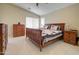 Bright main bedroom with tile flooring, a fan, and a matching bedroom set at 14298 W Amelia Ave, Goodyear, AZ 85395
