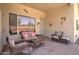 Relaxing covered patio with wicker furniture, perfect for outdoor lounging at 14298 W Amelia Ave, Goodyear, AZ 85395