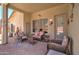 Inviting covered patio with comfortable seating, ideal for entertaining and relaxing at 14298 W Amelia Ave, Goodyear, AZ 85395