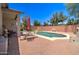 Beautiful backyard featuring a refreshing pool, red brick patio, and outdoor dining area at 14298 W Amelia Ave, Goodyear, AZ 85395