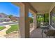 Relaxing covered front porch with comfortable seating and great curb appeal at 14298 W Amelia Ave, Goodyear, AZ 85395
