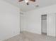 A bedroom featuring a ceiling fan, neutral carpet, closet and white walls at 16938 N Verde Pl, Maricopa, AZ 85138