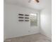 A neutral bedroom showcasing floating shelves, a ceiling fan and neutral carpet at 16938 N Verde Pl, Maricopa, AZ 85138