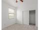 Bright bedroom featuring neutral carpet, a ceiling fan, a window, and a closet with sliding doors at 16938 N Verde Pl, Maricopa, AZ 85138