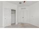 A bedroom featuring a ceiling fan, neutral carpet, closet and white walls at 16938 N Verde Pl, Maricopa, AZ 85138