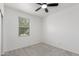 Neutral bedroom featuring a ceiling fan, window with blinds, and plush carpet at 16938 N Verde Pl, Maricopa, AZ 85138