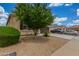 Desert landscaping surrounds this home, with a driveway leading to a two-car garage at 16938 N Verde Pl, Maricopa, AZ 85138