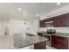 Kitchen features stainless steel appliances, granite countertops, island, and dark cabinetry at 16938 N Verde Pl, Maricopa, AZ 85138