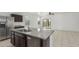 Bright kitchen with granite countertops, stainless steel appliances, and island sink at 16938 N Verde Pl, Maricopa, AZ 85138