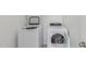 Bright laundry room featuring white appliances and plenty of room for storage at 16938 N Verde Pl, Maricopa, AZ 85138