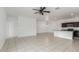 Open floor plan with tile flooring, ceiling fan, modern kitchen with stainless steel appliances at 16938 N Verde Pl, Maricopa, AZ 85138