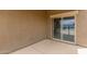 Covered back patio with a sliding glass door offering seamless access to the home at 16938 N Verde Pl, Maricopa, AZ 85138