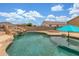 Relaxing pool with custom rock waterfall feature and slide provides backyard fun at 16938 N Verde Pl, Maricopa, AZ 85138