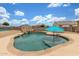 Backyard pool with desert landscaping and a built-in spa, ideal for outdoor relaxation and entertaining at 16938 N Verde Pl, Maricopa, AZ 85138