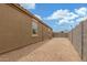 Side yard featuring low-maintenance landscaping and privacy wall at 16938 N Verde Pl, Maricopa, AZ 85138