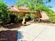 Beautiful backyard with mature trees, landscaping, and patio area is perfect for relaxing or entertaining at 18166 W Camino Real Dr, Surprise, AZ 85374