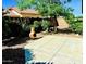 Backyard features patio area with a decorative firepit, providing a comfortable outdoor space at 18166 W Camino Real Dr, Surprise, AZ 85374