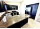 Kitchen featuring granite counters, stainless steel appliances, and dark cabinets at 18166 W Camino Real Dr, Surprise, AZ 85374