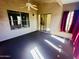 Inviting sunroom with tile flooring, ceiling fan, and access to the outdoors is perfect for entertaining at 18166 W Camino Real Dr, Surprise, AZ 85374