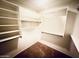 Walk-in closet with shelves and hanging bars for plenty of storage space at 18166 W Camino Real Dr, Surprise, AZ 85374