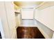 Walk-in closet with shelves and hanging bars for organized storage at 18166 W Camino Real Dr, Surprise, AZ 85374