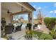 Inviting outdoor patio with seating area, overhead fan, desert landscaping, and a refreshing swimming pool at 18366 N Arbor Dr, Maricopa, AZ 85138