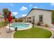 Relaxing backyard features a private pool, green grass, and desert landscaping at 18366 N Arbor Dr, Maricopa, AZ 85138