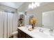 Bathroom featuring double sinks, a large mirror, and a shower with a curtain at 18366 N Arbor Dr, Maricopa, AZ 85138