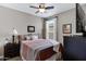 Inviting bedroom with dark furniture, patterned bedding, and lots of natural light at 18366 N Arbor Dr, Maricopa, AZ 85138