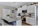 White kitchen cabinets and granite countertops with an island, and stainless steel appliances at 18366 N Arbor Dr, Maricopa, AZ 85138