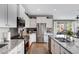 Well-lit, modern kitchen with stainless steel appliances and granite countertops, flowing into the open-concept living space at 18366 N Arbor Dr, Maricopa, AZ 85138