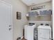 Laundry room featuring a washer, a dryer, and overhead shelving for storage at 18366 N Arbor Dr, Maricopa, AZ 85138