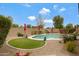Secluded backyard oasis featuring a sparkling pool, manicured lawn, and desert landscaping at 18366 N Arbor Dr, Maricopa, AZ 85138