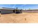 Spacious backyard featuring desert landscaping, covered patio, and a block fence for privacy at 18427 N 32Nd Ln, Phoenix, AZ 85053