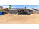 Large backyard with potential, including covered patio, desert landscaping, and a block fence at 18427 N 32Nd Ln, Phoenix, AZ 85053