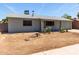 Single-story home with a light gray paint, minimal landscaping, and a two-car garage at 18427 N 32Nd Ln, Phoenix, AZ 85053