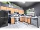 Functional kitchen featuring wooden cabinets, black appliances, and ample countertop space at 18427 N 32Nd Ln, Phoenix, AZ 85053