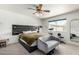 This is the main bedroom with a king-sized bed, a decorative headboard, and a ceiling fan at 18427 N 32Nd Ln, Phoenix, AZ 85053