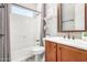Bathroom featuring shower and tub combo, a decoratively framed mirror, and modern fixtures at 30135 N 129Th Gln, Peoria, AZ 85383