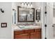 Bathroom featuring a decorative framed mirror, decorative tile backsplash, and stylish fixtures at 30135 N 129Th Gln, Peoria, AZ 85383