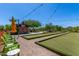 Enjoy outdoor games on the bocce ball court with shade umbrellas and seating under bistro lighting at 30135 N 129Th Gln, Peoria, AZ 85383