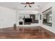 Spacious living room with hardwood floors, stone fireplace and large windows offering plenty of natural light at 30135 N 129Th Gln, Peoria, AZ 85383