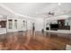 Open-concept living space featuring hardwood floors, stone media center and large windows offering lots of natural light at 30135 N 129Th Gln, Peoria, AZ 85383