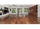 Open-concept living room with gleaming hardwood floors, built-in cabinetry, and pool views at 30135 N 129Th Gln, Peoria, AZ 85383